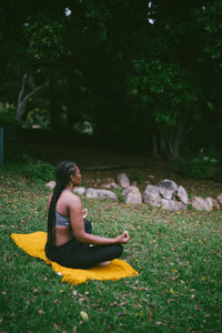 person meditating on yoga mat